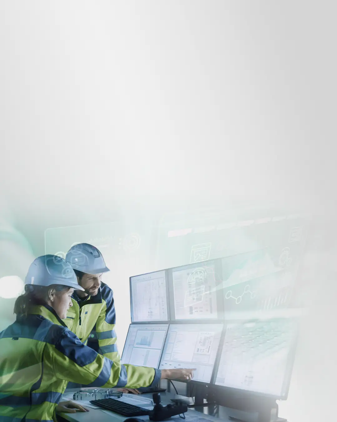 Two industrial engineers using connectivity software on large monitors in an industrial setting to integrate OT and IT systems with Kepware, OPC Router, and Industry 4.0 solutions.